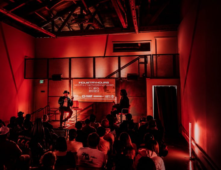 Industry Hours networking mixer, room washed in red light
